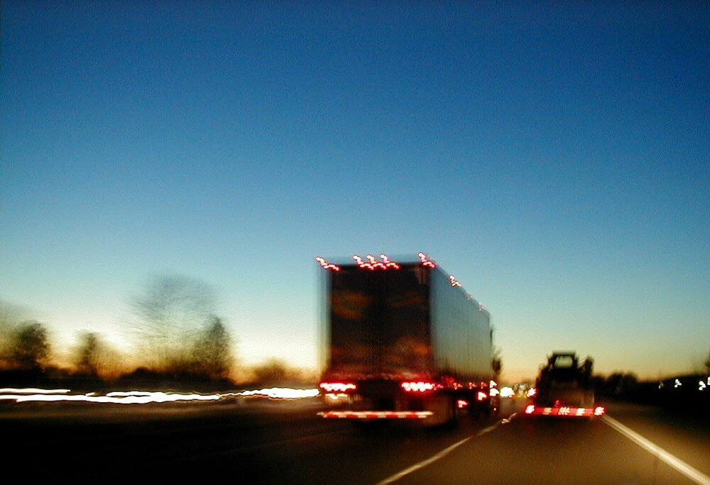 A truck on the highway at dusk