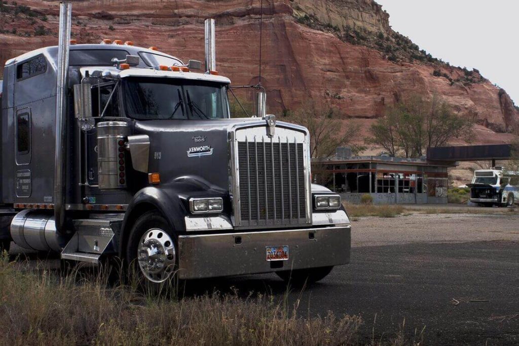 a semi-truck parked at an old truck stop