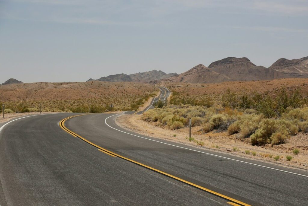 empty highway with mountains in the distance