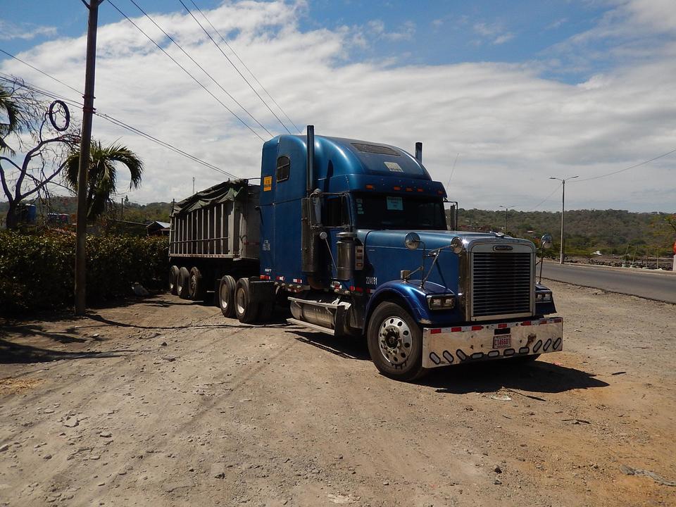 blue-truck-parked-on-the-roadside