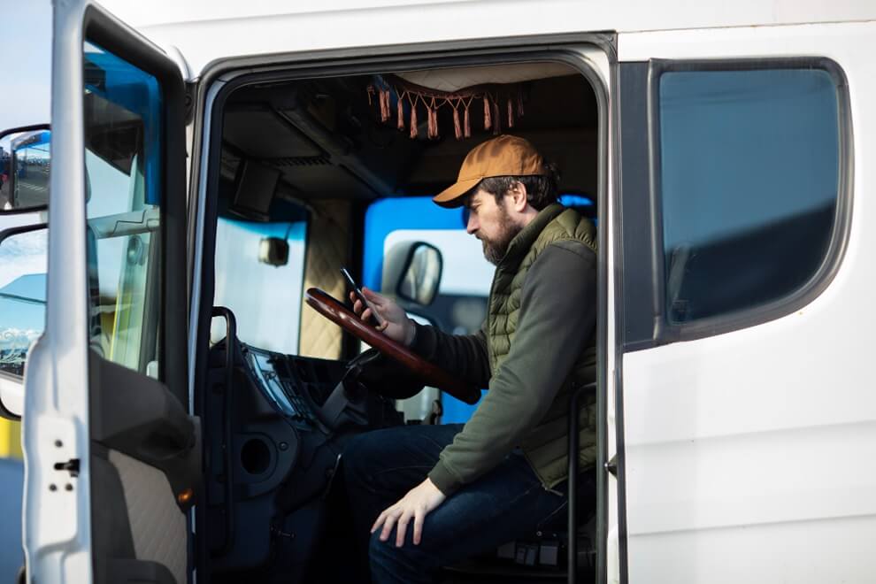 a trucker sitting in a parked semi truck