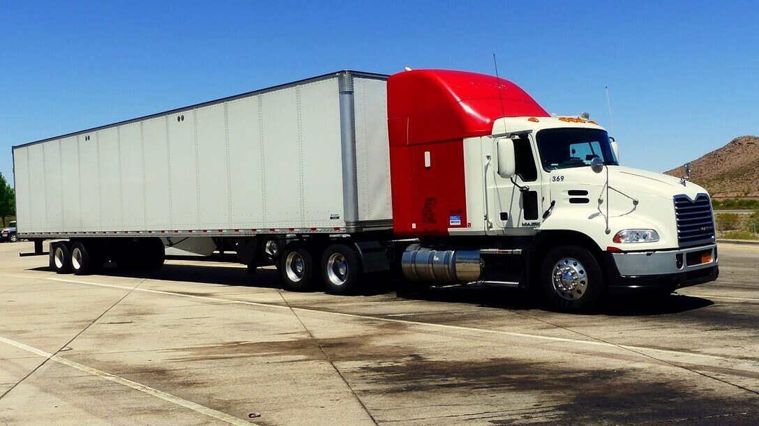 truck parking lot owner standing in front of parked trucks