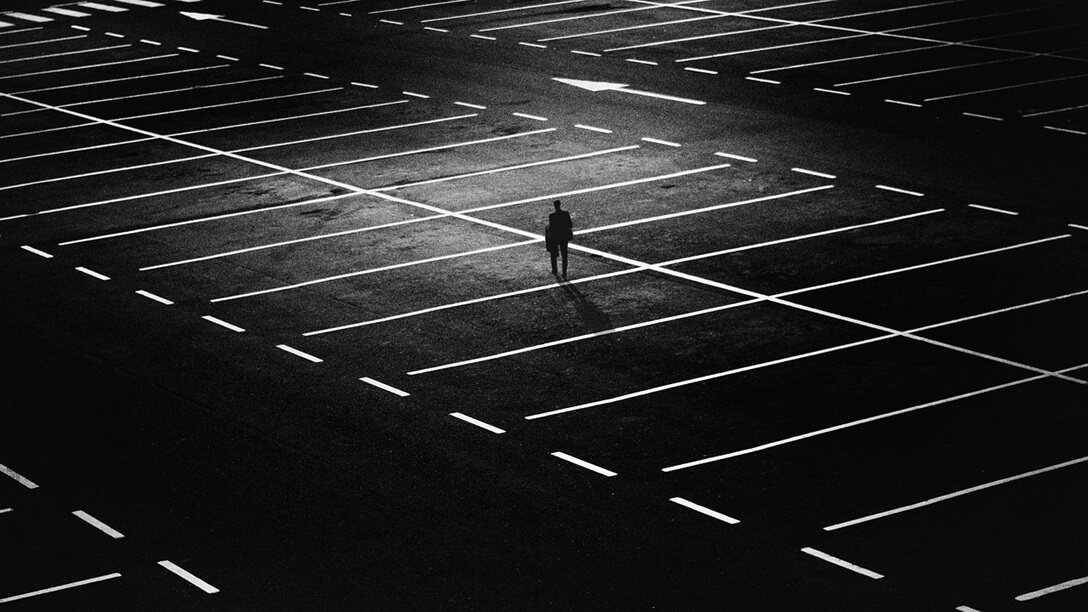 A man in the middle of parking lot