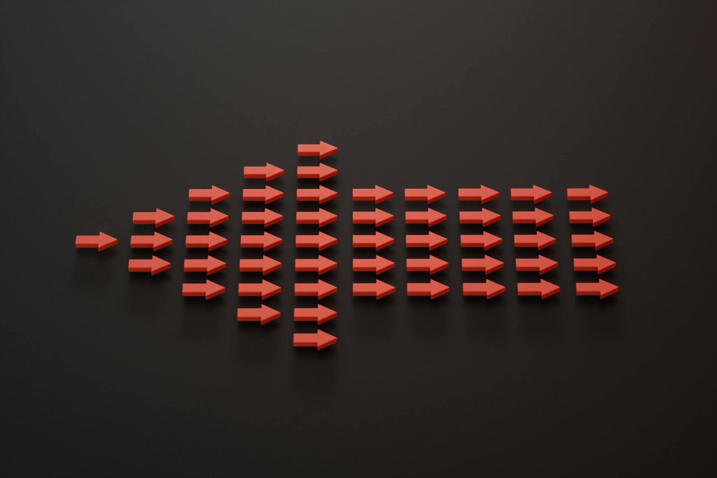 a group of red arrows on a black surface