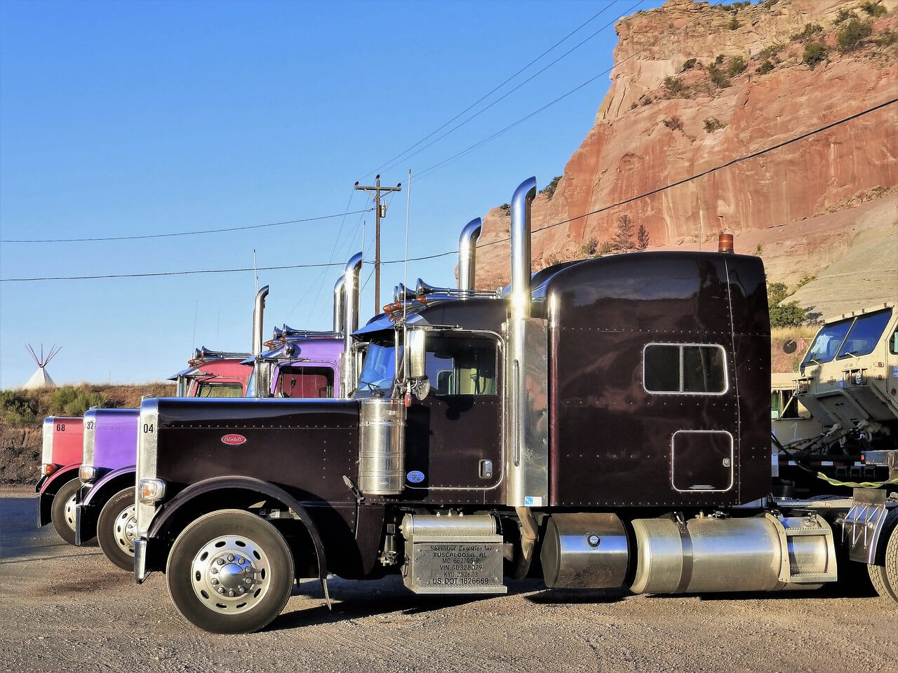 a row of trucks parked in a lot